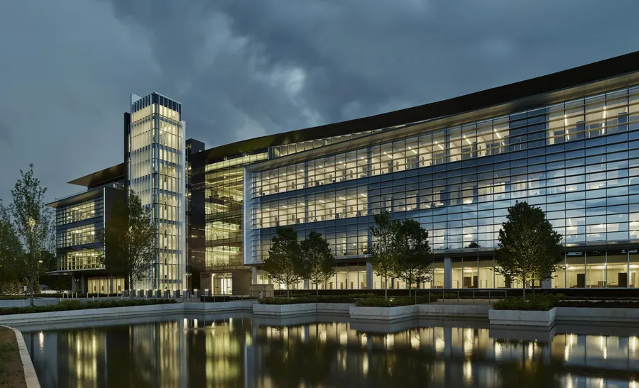 A large glass building beside water