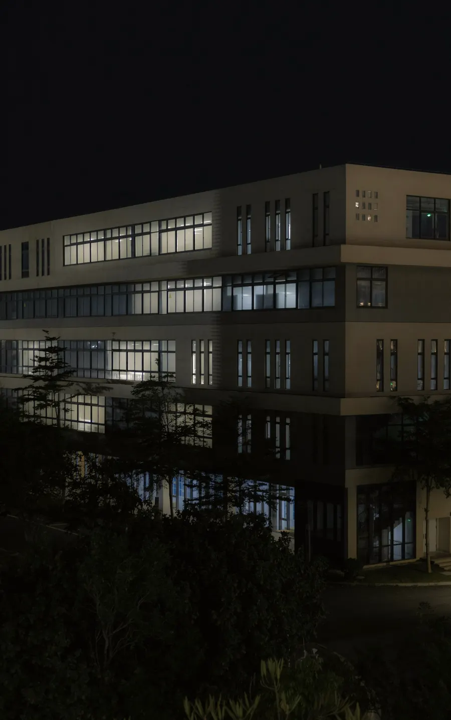 A modern office building lit up at night